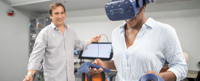 Associate professor Kim Grinfeder explores interactive media technologies with student Chelsea Lovell. Photo: Mariano Copello for the University of Miami