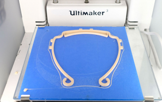 A face shield 3-D prints at Zeven Rodriguez's house. Photo courtesy of Zeven Rodriguez.