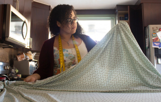 Lorena Lopez measures fabric for face masks to prevent the spread of COVID-19. Photo courtesy of Lorena Lopez.