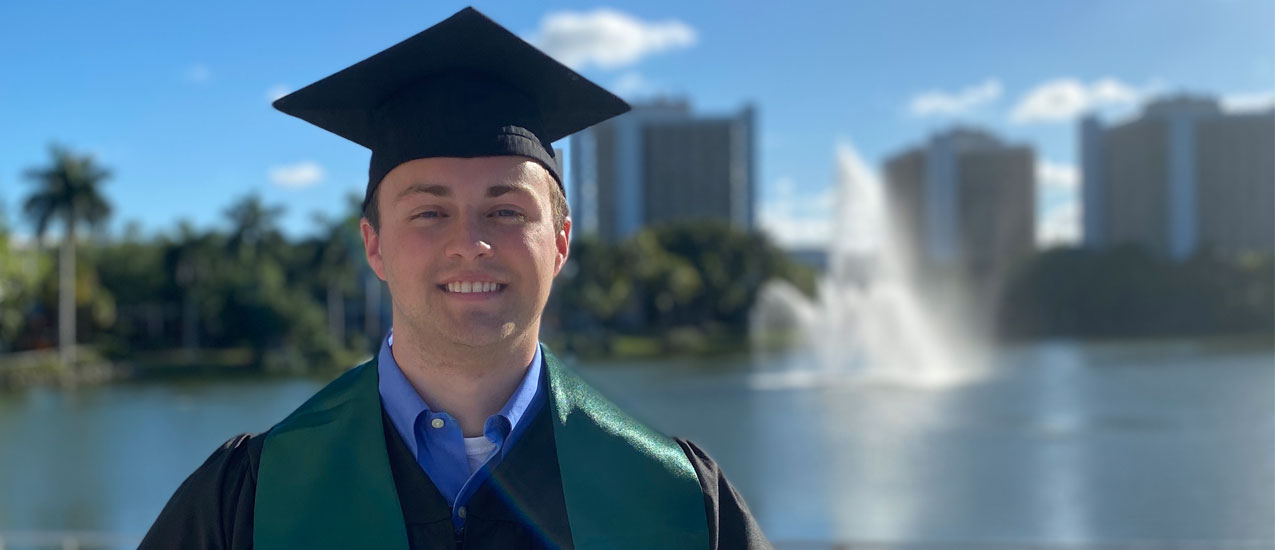 Ben Ezzy dons his graduation cap for a photo on the Coral Gables campus. Photo courtesy of Ben Ezzy.