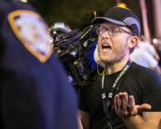 Associated Press videojournalist Robert Bumsted reminds a police officer that the press are considered "essential workers" and are allowed to be on the streets despite a curfew, Tuesday, June 2, 2020, in New York. Photo: Associated Press