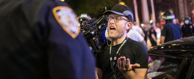 Associated Press videojournalist Robert Bumsted reminds a police officer that the press are considered "essential workers" and are allowed to be on the streets despite a curfew, Tuesday, June 2, 2020, in New York. Photo: Associated Press