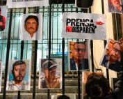 A woman posts photos of murdered journalists during a national protest against the murder of journalists in Mexico City on Jan. 25. Photo: The Associated Press