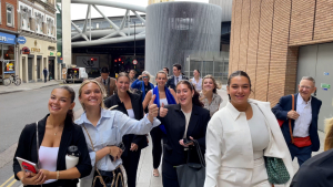 Smiling students walk the streets of London on their way to visit the Wall Street Journal.