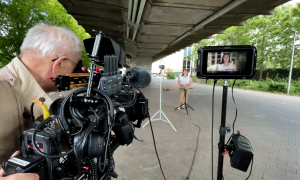 SoC student Maddie Bassalik, UMTV station manager, practices live shots on the streets of London with help from Brian Kelly, freelance videographer for ABC News.