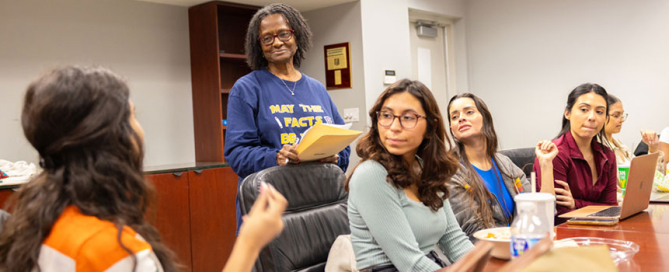 Tsitsi Wakhisi, second from left, associate professor of professional practice, teaches a graduate class on journalism. Photo: Joshua Prezant/University of Miami